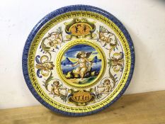 A Cantagalli Majolica plate, the raised central well, depicting Cupid surrounded by other