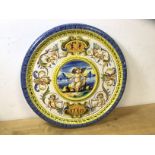 A Cantagalli Majolica plate, the raised central well, depicting Cupid surrounded by other