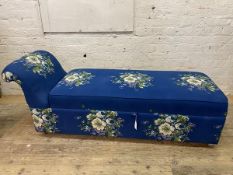 A mid century chaise ottoman with blue floral upholstery, hinged seat and castors, H70cm, L180cm,