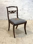 A Regency style side chair, with rope twist crest rail over drop in upholstered seat pad, raised