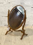 A Georgian style yew wood swing mirror, late 20th century, with bevelled oval mirror swivelling