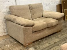 A contemporary two seat sofa, upholstered in natural fabric, raised on block supports, H80cm,