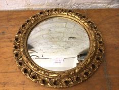 Circular convex wall mirror with gilt pierced composition frame, (42cm d)