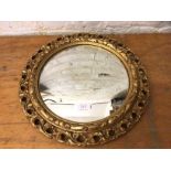 Circular convex wall mirror with gilt pierced composition frame, (42cm d)