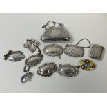 A collection of bottle labels, two silver, a silver matchcase, Birmingham, two silver brooches, an