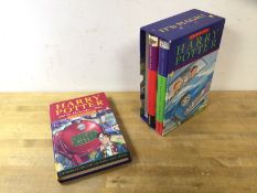 A boxed set of Harry Potter novels by J K Rowling, in hard back with dust jackets and slip case,
