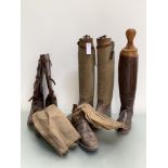 A pair of leather field boots with buckles, a pair of canvas and leather boots and wooden treds