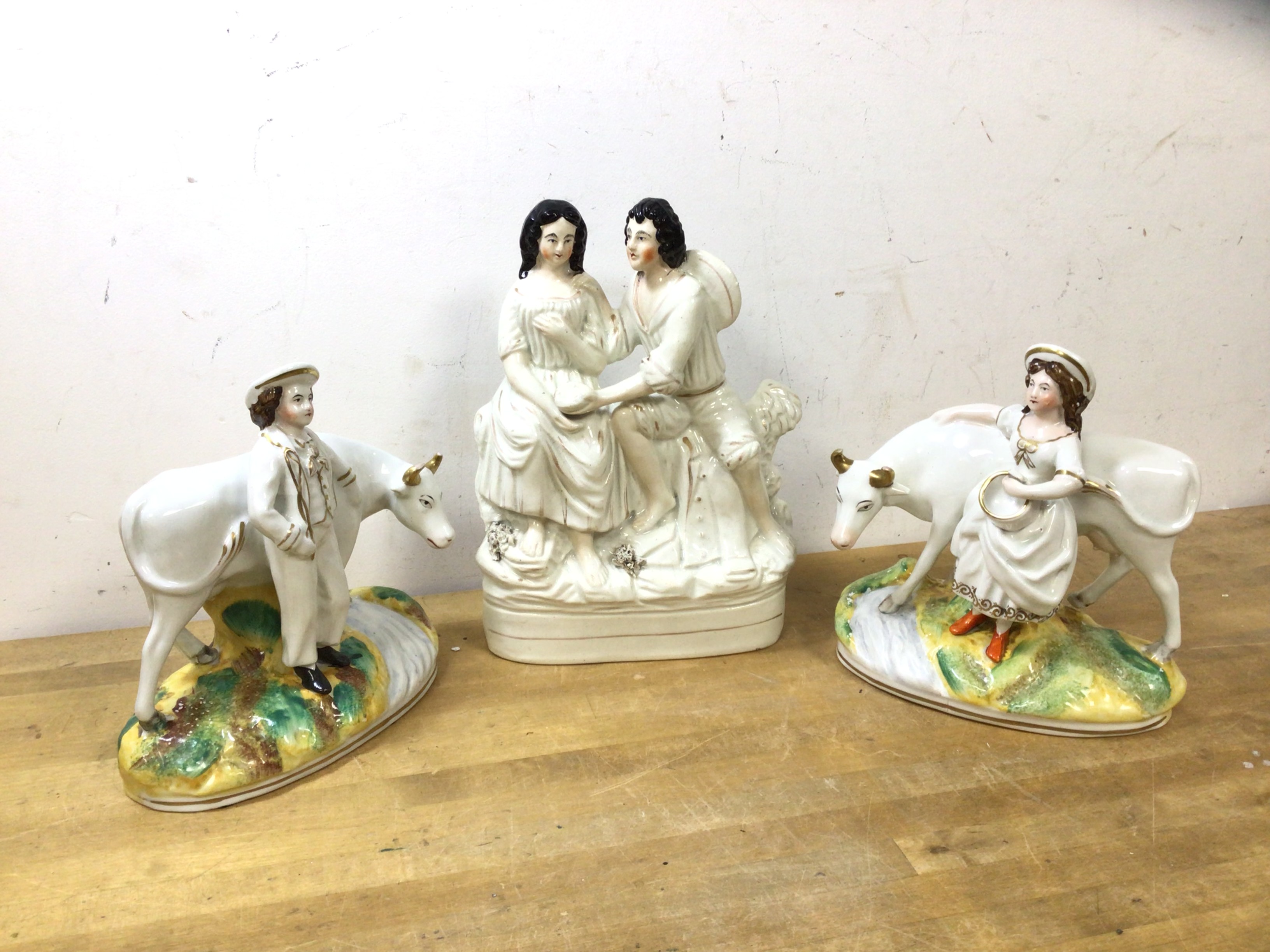 A group of Staffordshire figures including a courting couple (23cm h) and two of a man and woman