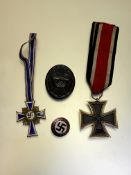 WWII German medals and badges to include Iron Cross 2nd Class Mother's Cross wound badge etc.