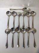 A set of twelve silver soup spoons, London 1982, maker RC, (15cm), a table spoon dated 1974,