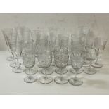 A collection of stemware including sherry and port glasses, all with engraved geometric