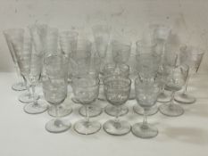 A collection of stemware including sherry and port glasses, all with engraved geometric