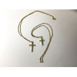 A crucifix marked 375, with engine turned decoration, on trace link chain marked 18ct, a crucifix,