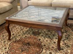 A mahogany framed low coffee table, the top with bevelled plate glass over a lattice work panel with