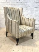 A Victorian wingback easy chair, upholstered in a striped floral green and ivory ground silk fabric,