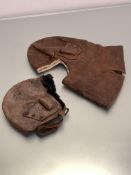 Two WWI period leather flying helmets, the smaller, leather with wool and fur lining (losses and