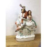 A 19thc Staffordshire Poor Man's Clock with courting Scottish couple above clock, (37cm h)