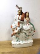 A 19thc Staffordshire Poor Man's Clock with courting Scottish couple above clock, (37cm h)