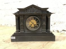 A Victorian slate mantle clock of architectural form, the arched pediment over frieze with Romo-