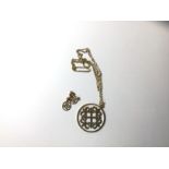 A medieval style open work pendant marked 9ct, on trace link chain, and matching pair of earrings,