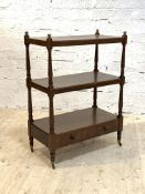A Victorian three tier mahogany whatnot, each tier on turned supports, with drawer to base, raised