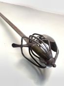 A Scottish steel basket hilted sword, the hilt with steel bar construction, steel pommel, leather