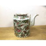 A Chinese teapot with rose, bird and butterfly decoration, a dished top, chips to rim, lacking