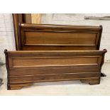 A king sized 5' hardwood sleigh bed, with scrolled head and foot board and slatted base, H103cm,