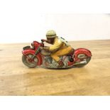 A late 1940's early 50's Schuco toy motor bike and rider, inscribed to base Made in US Zone,