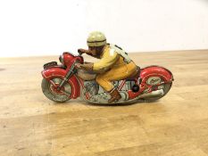 A late 1940's early 50's Schuco toy motor bike and rider, inscribed to base Made in US Zone,
