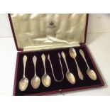 A set of six Edwardian silver coffee spoons and sugar nips, London, in original box marked Curtis