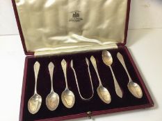 A set of six Edwardian silver coffee spoons and sugar nips, London, in original box marked Curtis