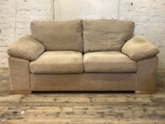 A contemporary three seat sofa, upholstered in natural fabric, raised on block supports, H84cm,