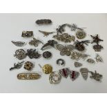A collection of brooches and clips, costume jewellery, some silver, polished stones, paste pearls