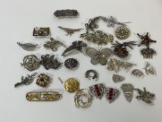 A collection of brooches and clips, costume jewellery, some silver, polished stones, paste pearls