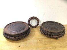 Two carved circular Chinese stands, (larger 8.5cm x 28cm), a stand or possible lamp base, lacking