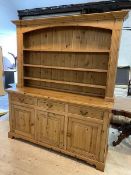 A modern pine dresser, the plate rack with three shelves within pilaster supports and moulded