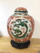 An early 20thc Chinese ginger jar with three panels, each depicting dragon chasing flaming pearl, on
