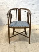 An Edwardian walnut tub shaped bedroom chair, the crest rail on splats with beeded moulding, over