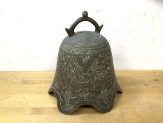 A South East Asian brass bell with naturalistic engraved decoration, lacking clapper, (19cm high)
