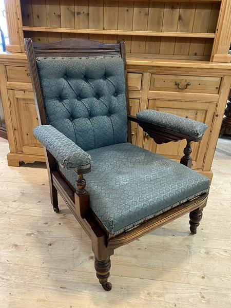 A late 19th early 20thc mahogany campaign open arm chair with buttoned back, upholstered cushioned