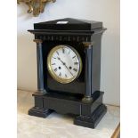 A Victorian slate mantel clock, of architectural form, with cast metal fluted pilasters enclosing