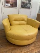 An oversized contemporary circular swivel lounge chair upholstered in yellow leather,( 84cm x