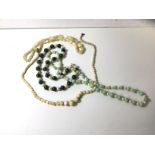 Two graduated moon stone bead necklaces, a pale celadon coloured jadeite and pearl necklace, a green