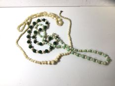 Two graduated moon stone bead necklaces, a pale celadon coloured jadeite and pearl necklace, a green