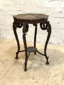 An unusual late 19th century walnut occasional table, the octagonal top carved in relief with