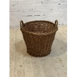 A twin handled wicker basket, H49cm, D51cm