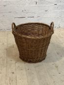 A twin handled wicker basket, H49cm, D51cm