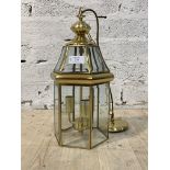 An Edwardian style brass octagonal three branch lantern with inset glass panels, late 20th