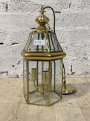 An Edwardian style brass octagonal three branch lantern with inset glass panels, late 20th